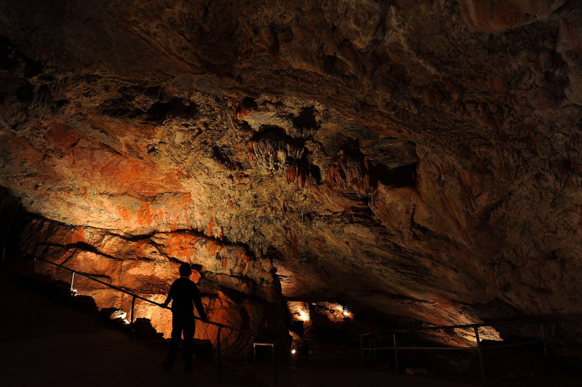 Silhouette person in a cave, Kents Cavern, Torquay, Devon