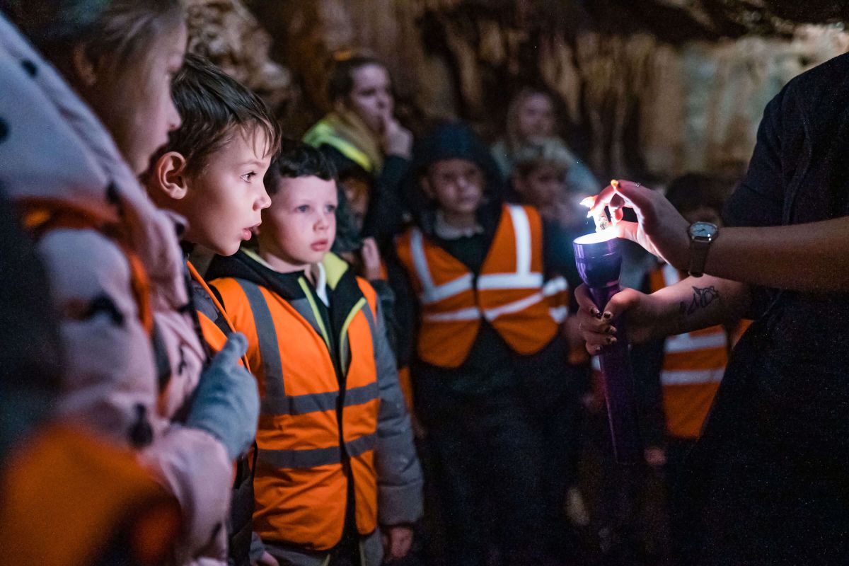 Children on a guided tour at Kents Cavern | Devon