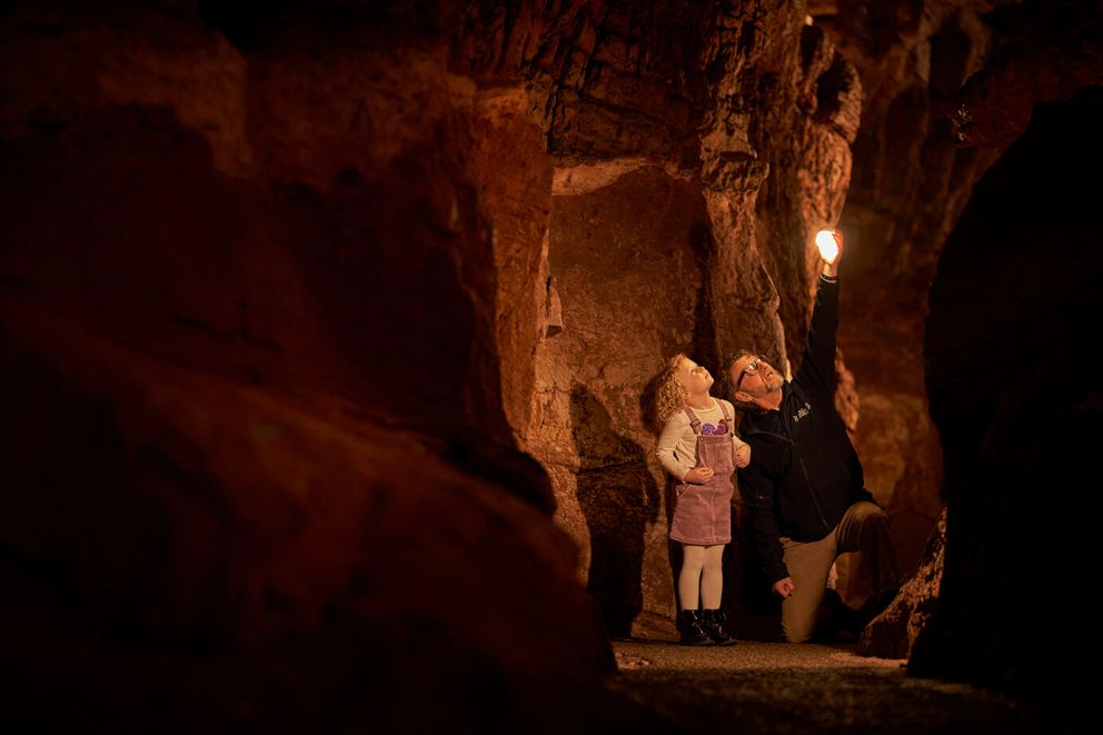 Tour guide and child | Kents Cavern, Devon
