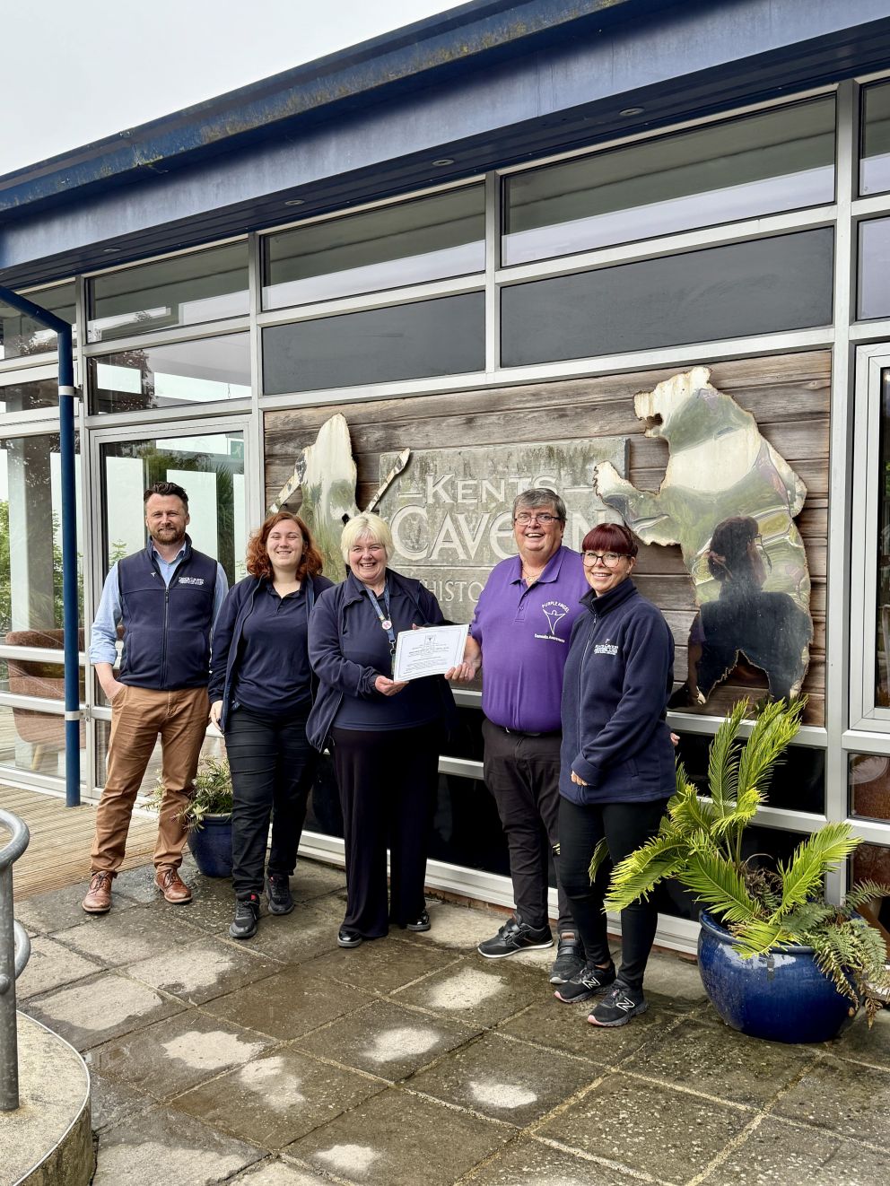 Kents Cavern team recieving their Purple Angel accreditation from Normal McNamara